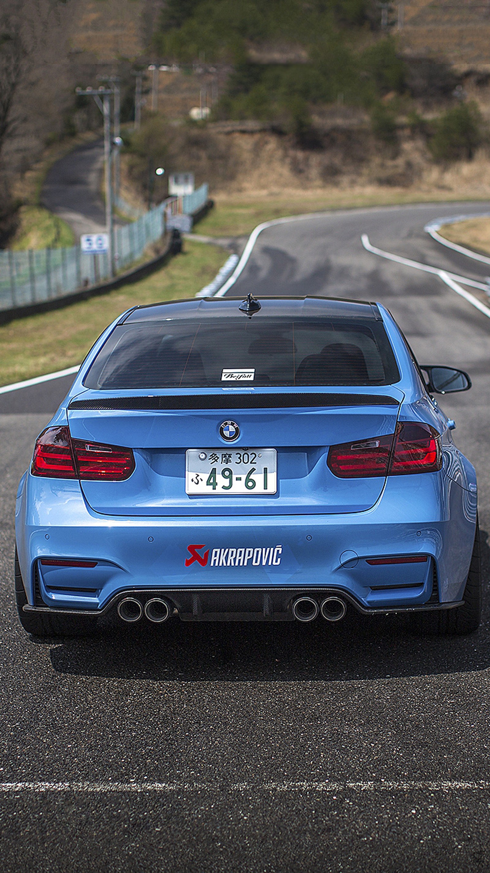 Arafed rear view of a blue bmw car on a road (akrapovic, beifall, blue, bmw, m3)