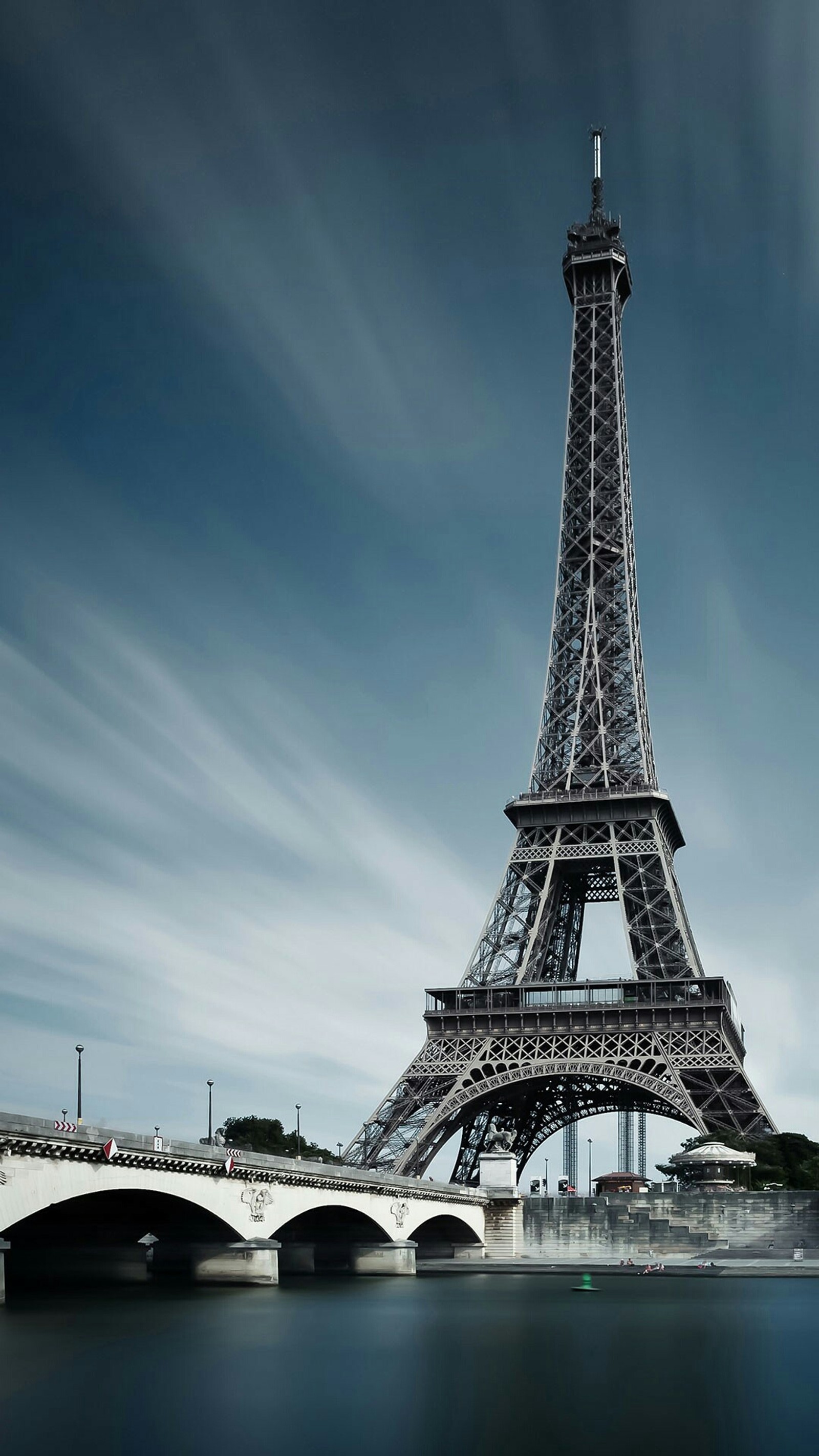 Arafed view of the eiffel tower with a bridge in the foreground (evil, paris, tower)