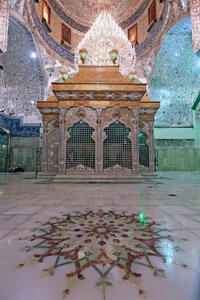 Sacred shrine of Imam Hussain with intricate mosaics and ornate chandeliers.