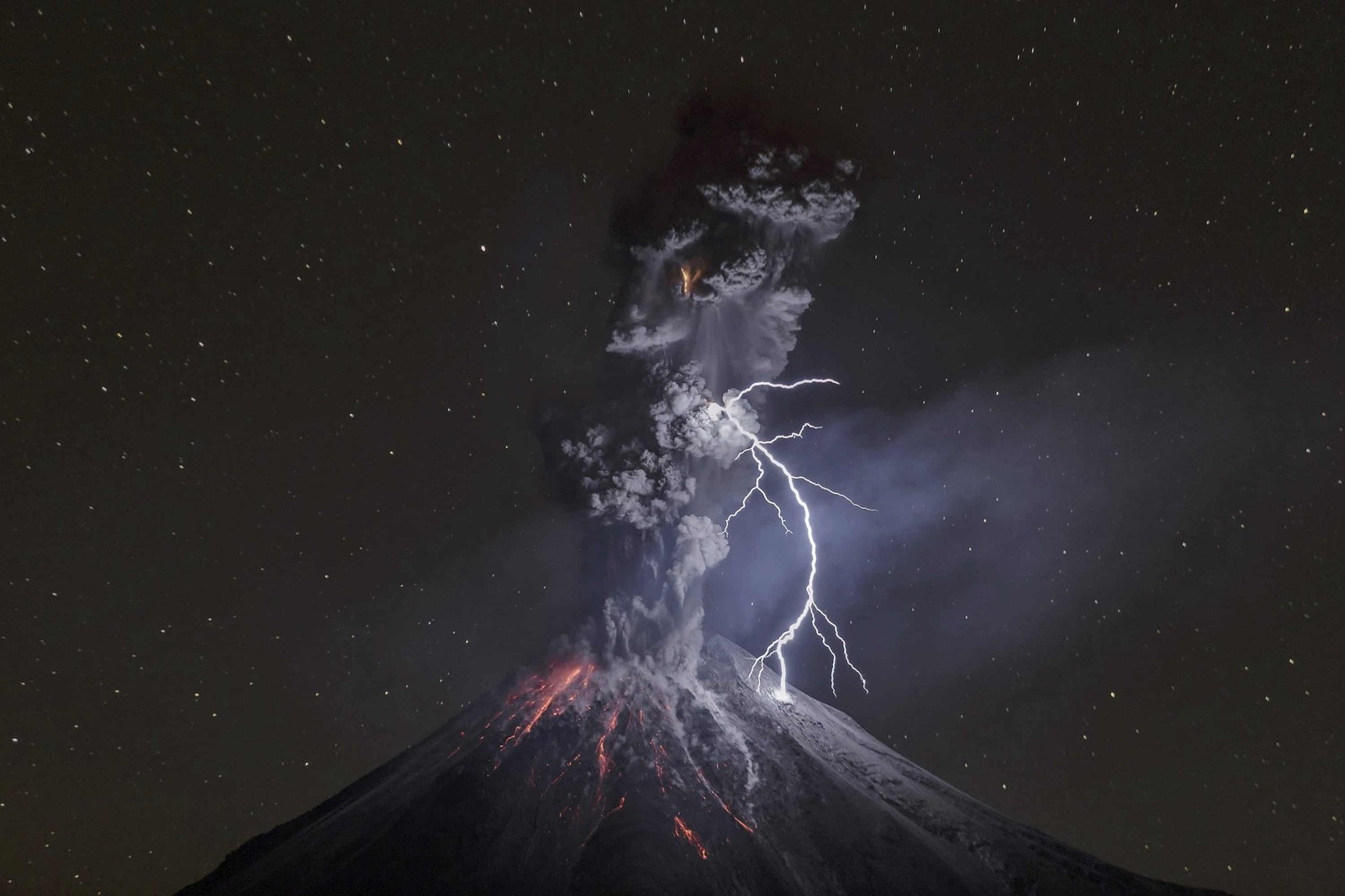 A close up of a volcano with a lightning bolt coming out of it (national geographic, award, night, space, atmosphere)