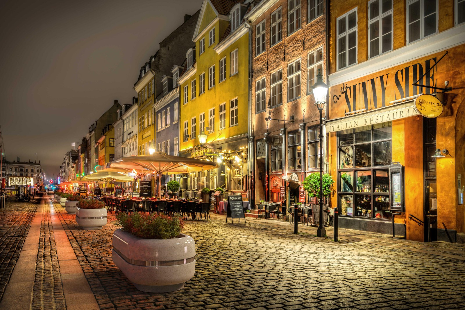 Vista panorámica de una calle con un restaurante al lado (estocolmo, stockholm, noche, pueblo, ciudad)