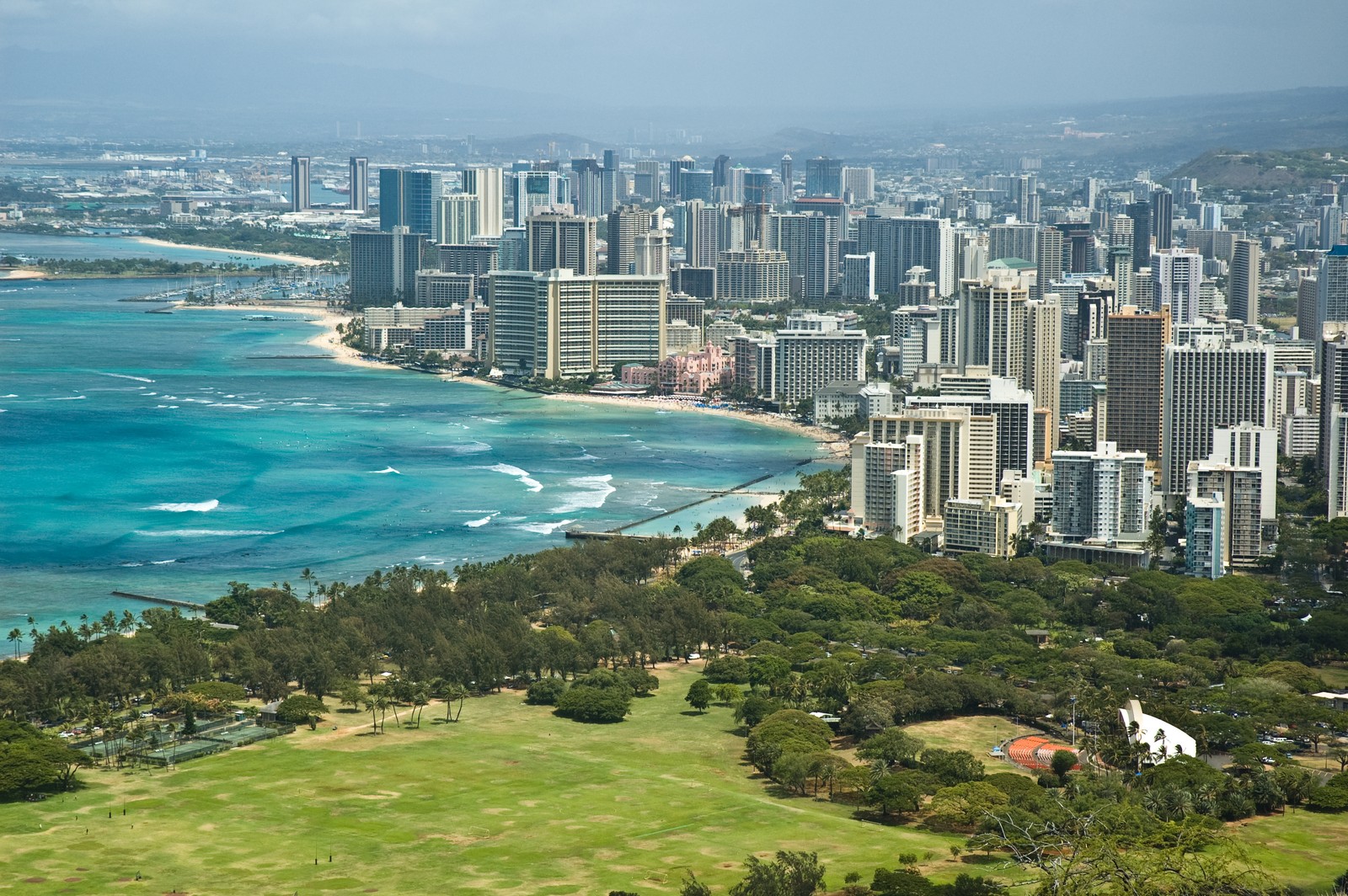 Uma vista aérea de uma cidade com uma praia e um corpo de água (waikiki, área urbana, paisagem urbana, cidade, dia)