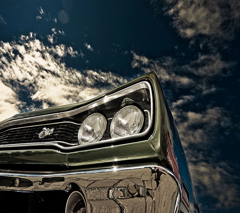 Arafed view of a classic car with a cloudy sky in the background (car, mpala)