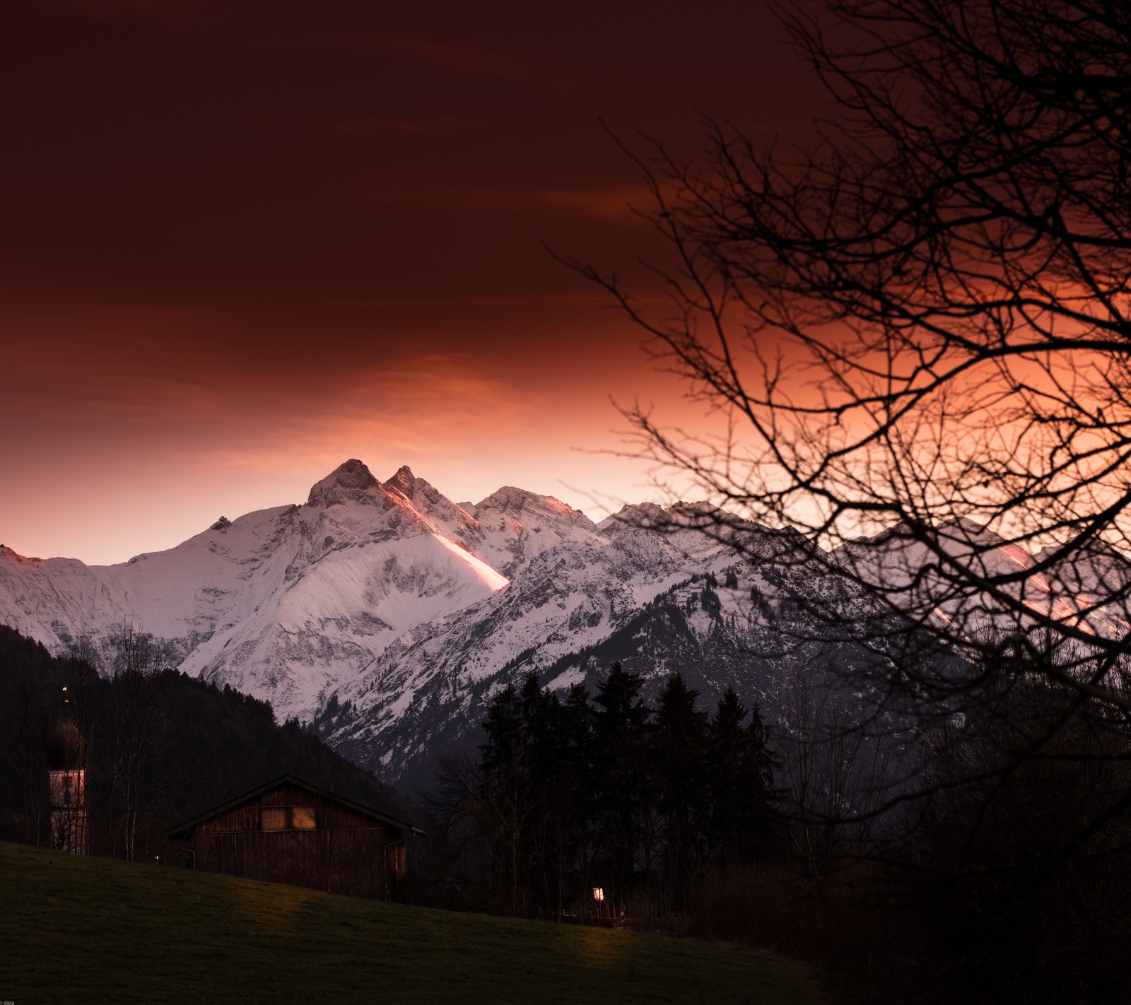 Mountains in the distance with a red sky and a few trees (cabin, landscape, mountain, nature, outdoor)