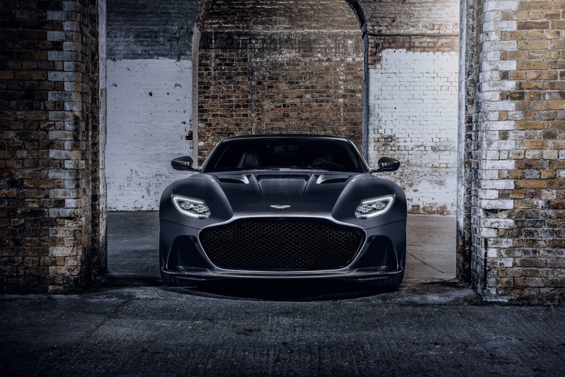 Черный автомобиль aston припаркован перед кирпичной стеной (aston martin dbs superleggera, издание 007, 2020, 5k, машины)