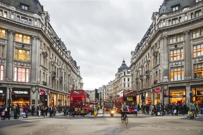 Busy Downtown Street Scene in London with Red Buses and Shoppers