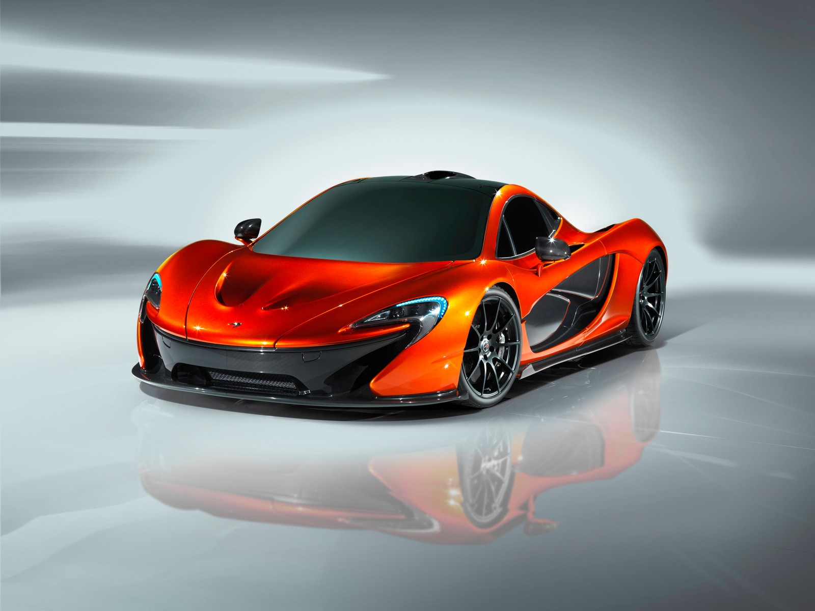 A close up of a red sports car on a reflective surface (mclaren automotive, mclaren, geneva motor show, car, paris motor show)