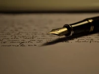 Pluma elegante sobre notas escritas a mano