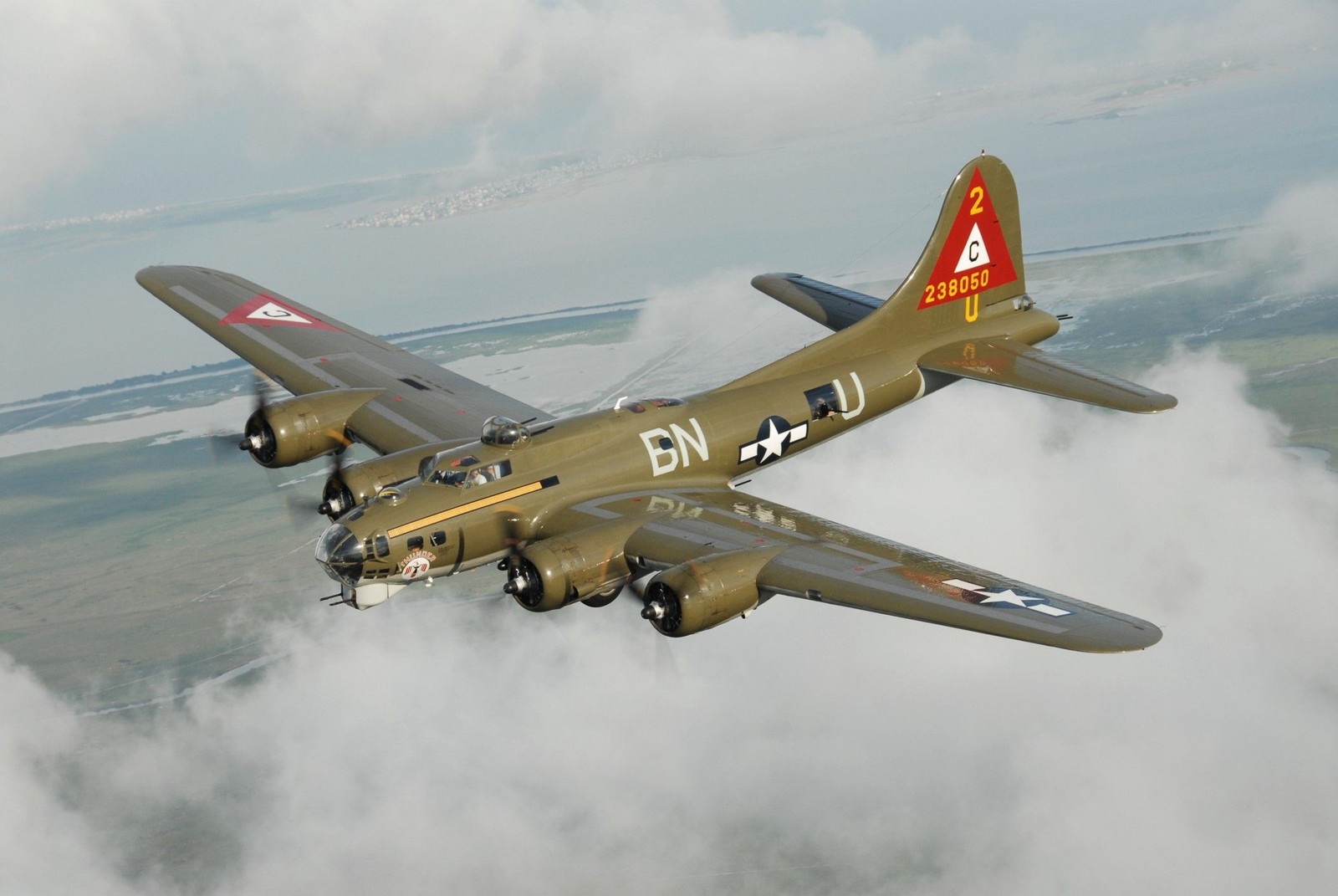 There is a large plane flying through the sky with clouds (boeing b 17 flying fortress, aircraft, airplane, flight, military aircraft)