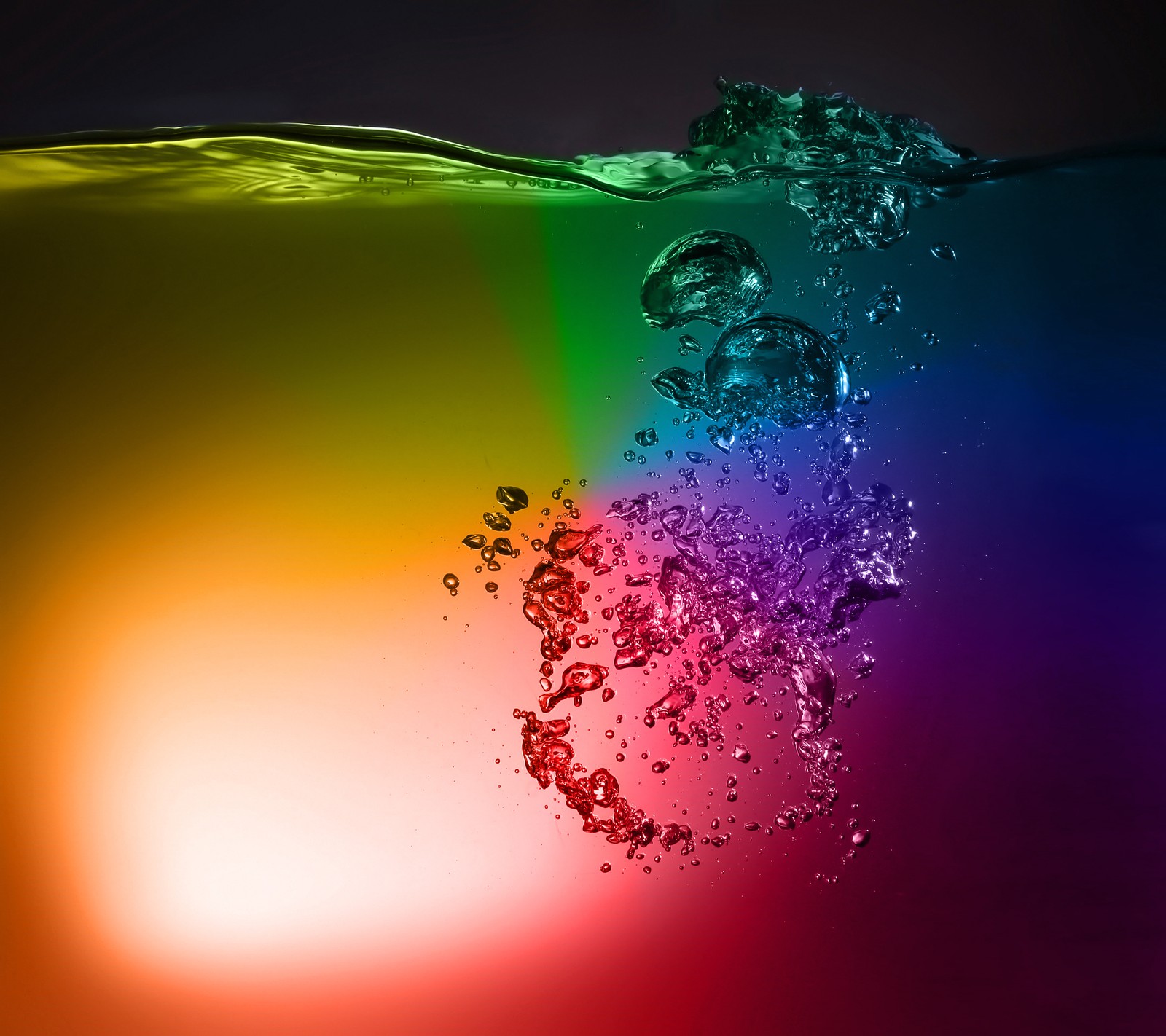 A close up of a rainbow colored liquid with bubbles coming out of it (aqua, aquarium, bubble, drops, multicolor)