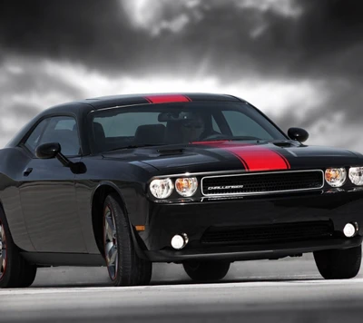 Black Dodge Challenger with red racing stripes under a dramatic sky.