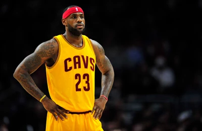 LeBron James in a yellow Cleveland Cavaliers jersey during the NBA Finals, showcasing his athletic build and focus on the game.