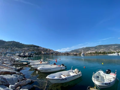 Serene Lake View with Boats and Mountain Backdrop