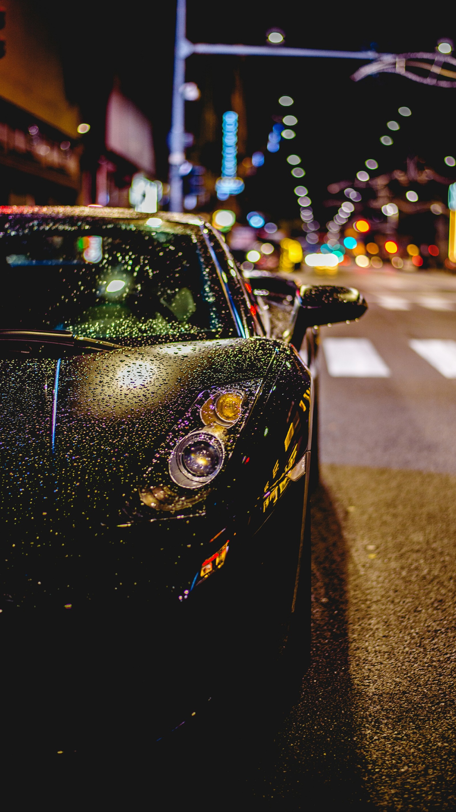 Arafed black sports car parked on the side of the road at night (auto, beauty, car, city, colorful)