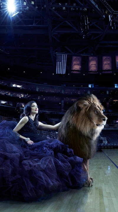 Majestic Encounter: A Woman in Black Elegance with a Regal Lion