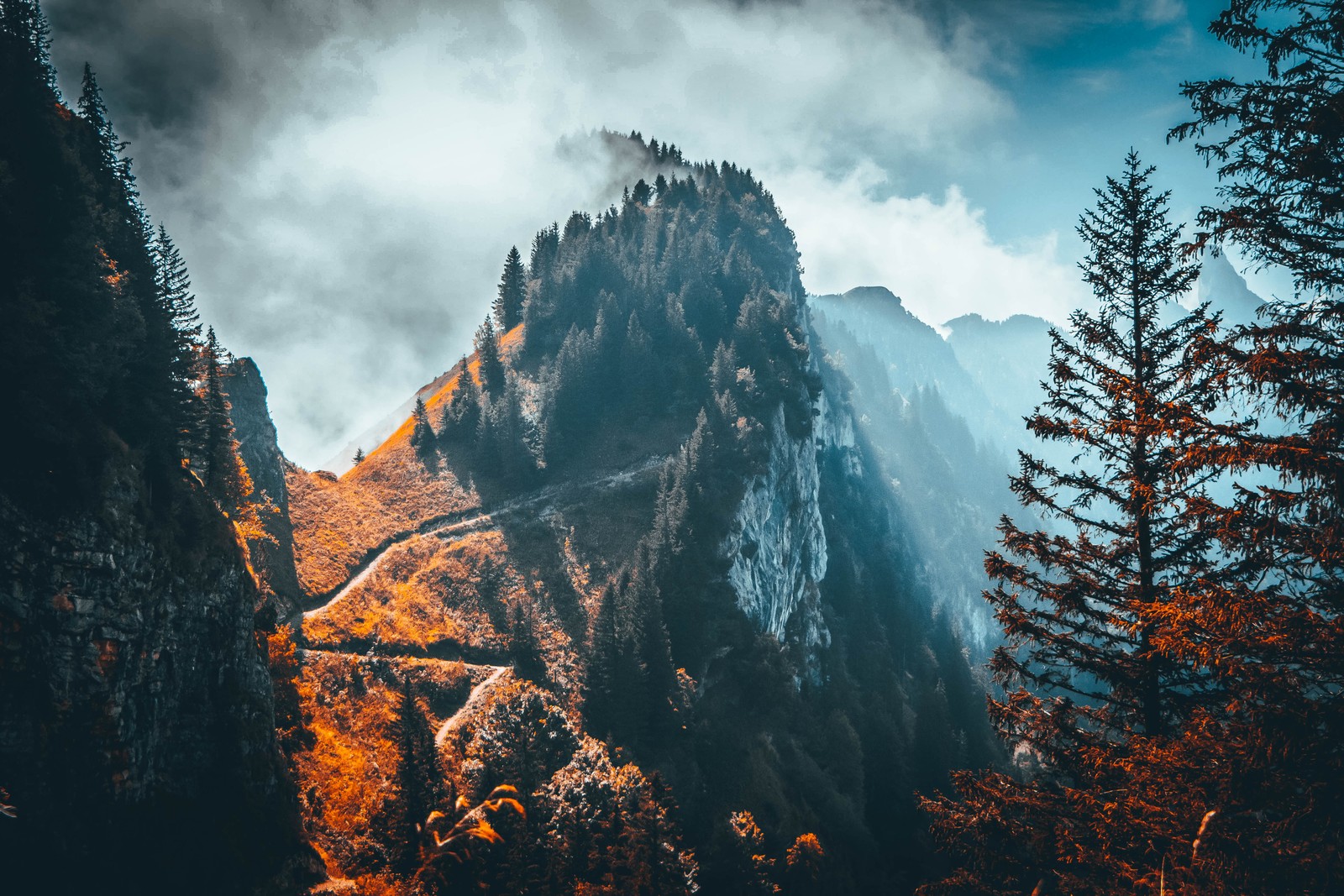 A mountain with a few trees and a cloudy sky (mountain, alps, nature, wilderness, sky)