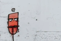 Personnage rouge fantaisiste avec une moustache sur un mur blanc