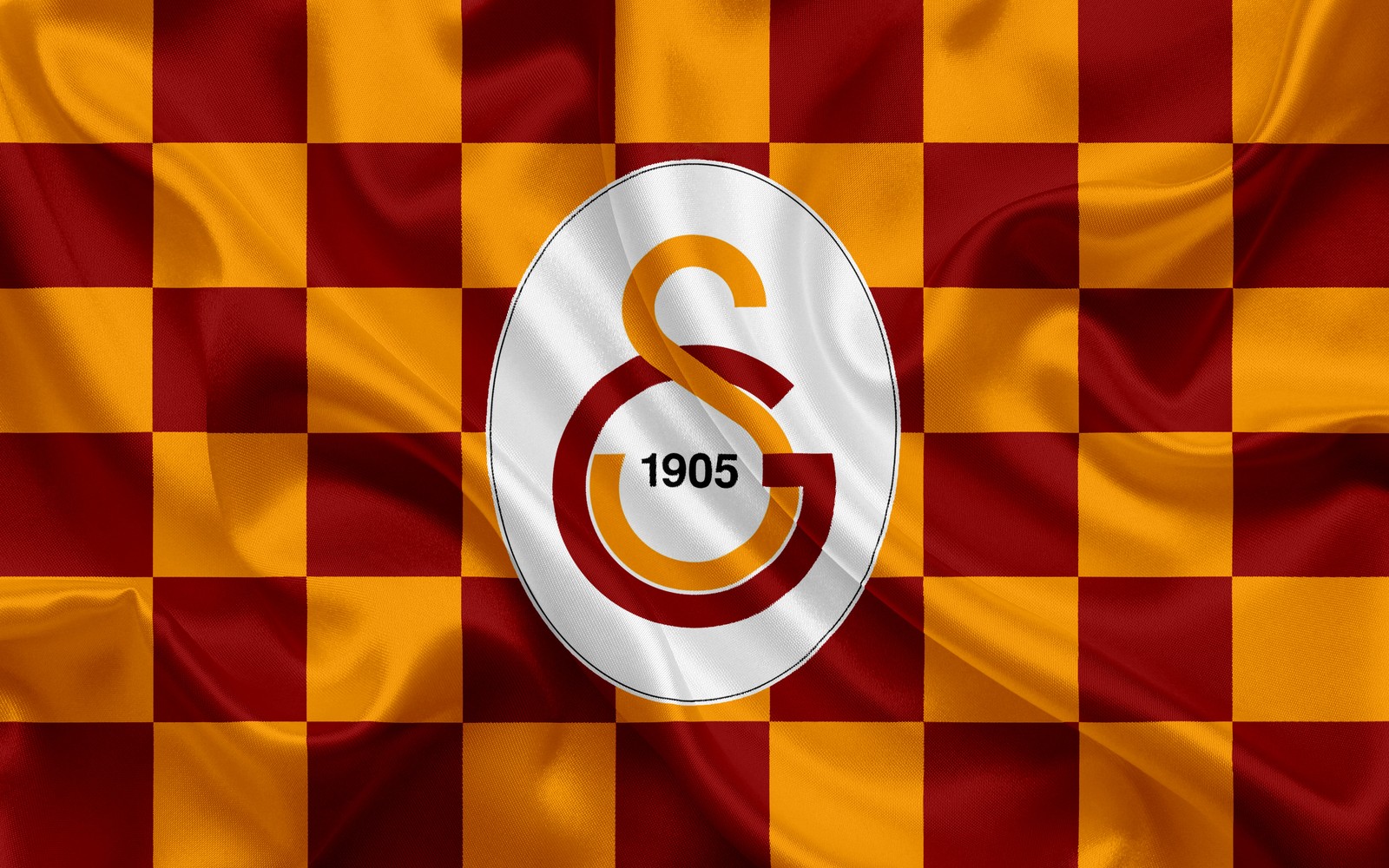 Un gros plan d'un tissu à carreaux rouge et jaune avec le numéro 3 blanc dessus (galatasaray, logo, club de football, ligue des champions de luefa, sports)