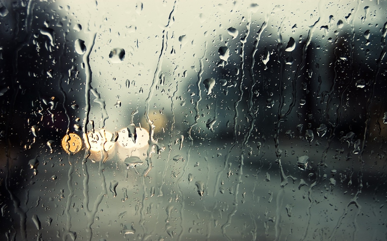 Vista de una ciudad a través de una ventana cubierta de lluvia (lluvia, agua, llovizna, precipitación, clima)