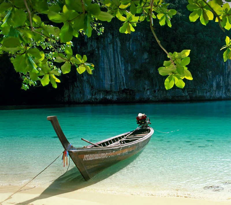 There is a boat that is sitting on the beach near the water (galaxy, money, naturaleza, paz, prosperidad)