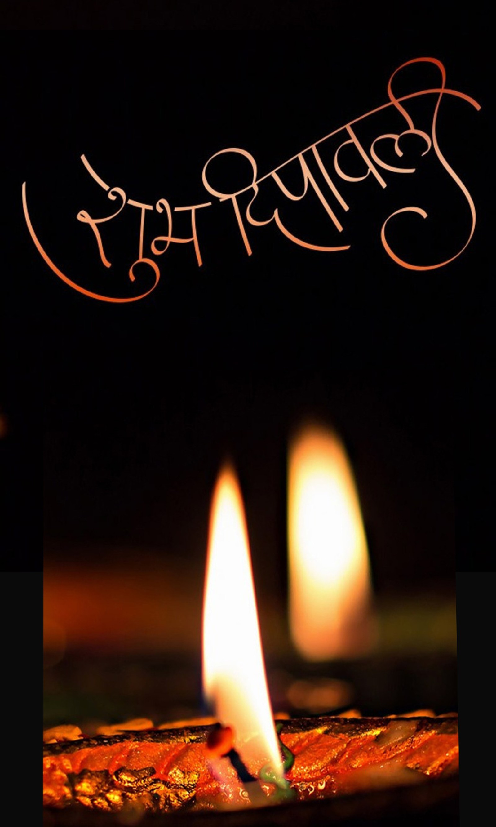 There is a lit candle with the words happy diwaling written on it (celebration, festival)