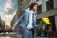 Stylish Man in Denim Blazer Holding Yellow Flowers