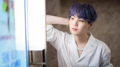 Suga of BTS: A Moment of Reflection in Soft Light