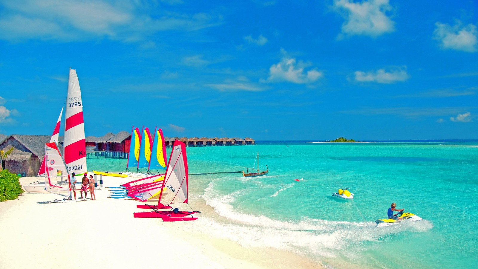 People are enjoying the beach and water sports on a sunny day (resort, vacation, beach, island, sea)