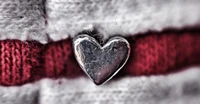 Close-Up of a Silver Heart on a Striped Background