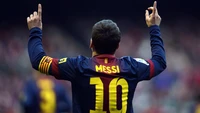 Lionel Messi celebrando en su camiseta del FC Barcelona, mostrando el icónico número 10.