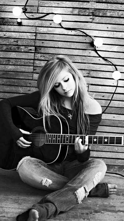 Avril Lavigne: Momento introspectivo com guitarra em preto e branco