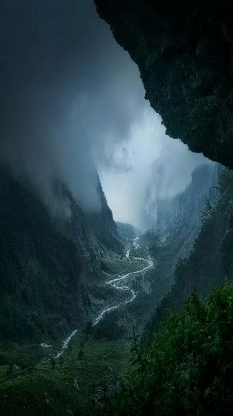 There is a view of a valley with a river in the middle (adventure, nature, night, river, sky)