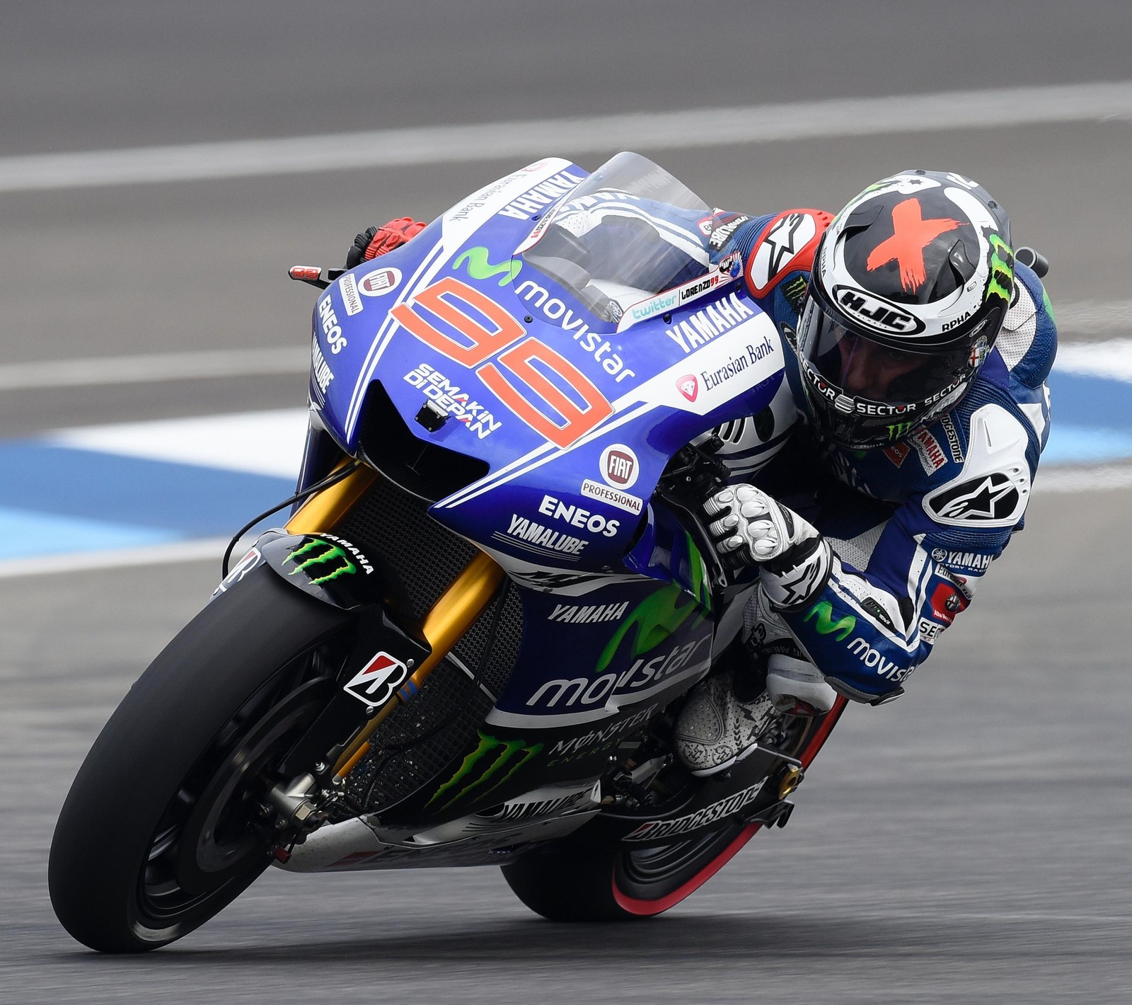 Arafed motorcycle racer leaning to take a corner on a track (moto gp, racing)