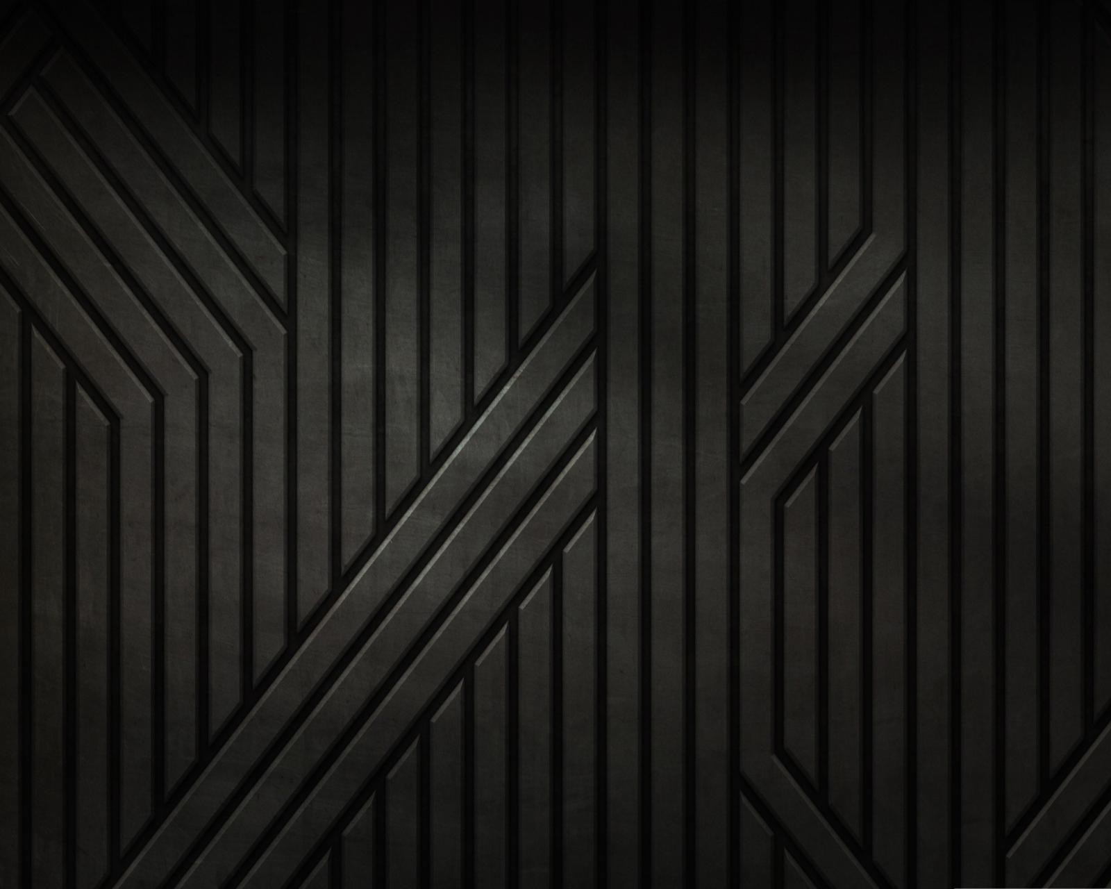 A close up of a black wall with a pattern of lines (abstract, texture)