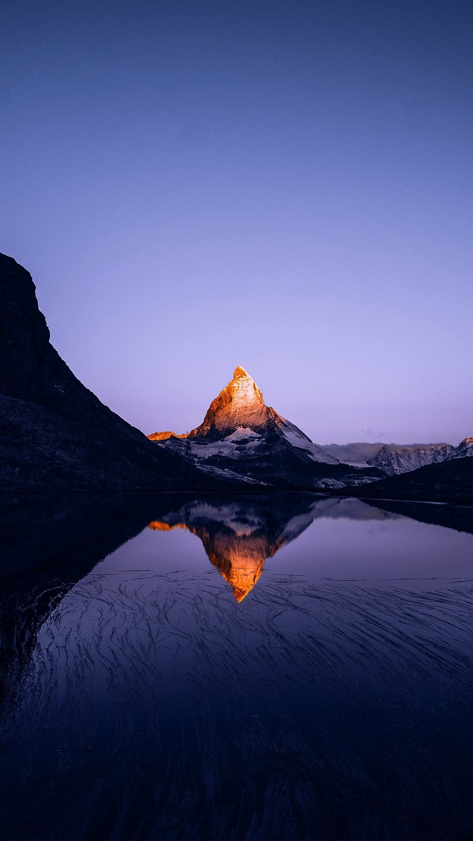 Arafed mountain reflected in a lake at dusk with a blue sky (mountain, snow, mountains, night, stars)