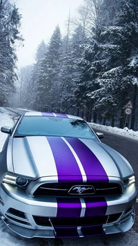 Ford Mustang with striking purple stripes parked on a snowy forest road.