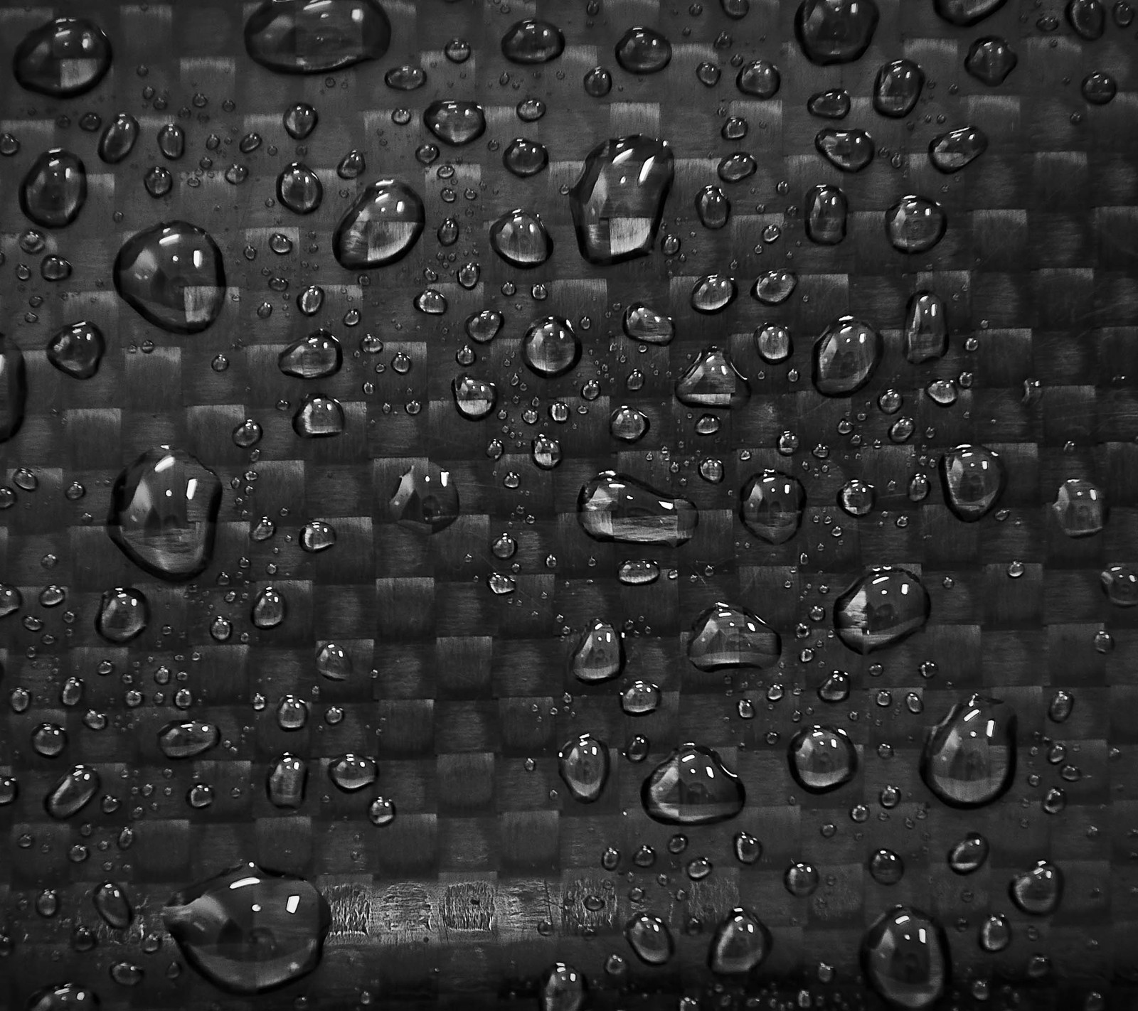 A close up of a black and white photo of water droplets (carbon, drop, fiber, fibre, texture)