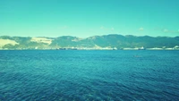 Tranquil Ocean View with Distant Shoreline and Mountains