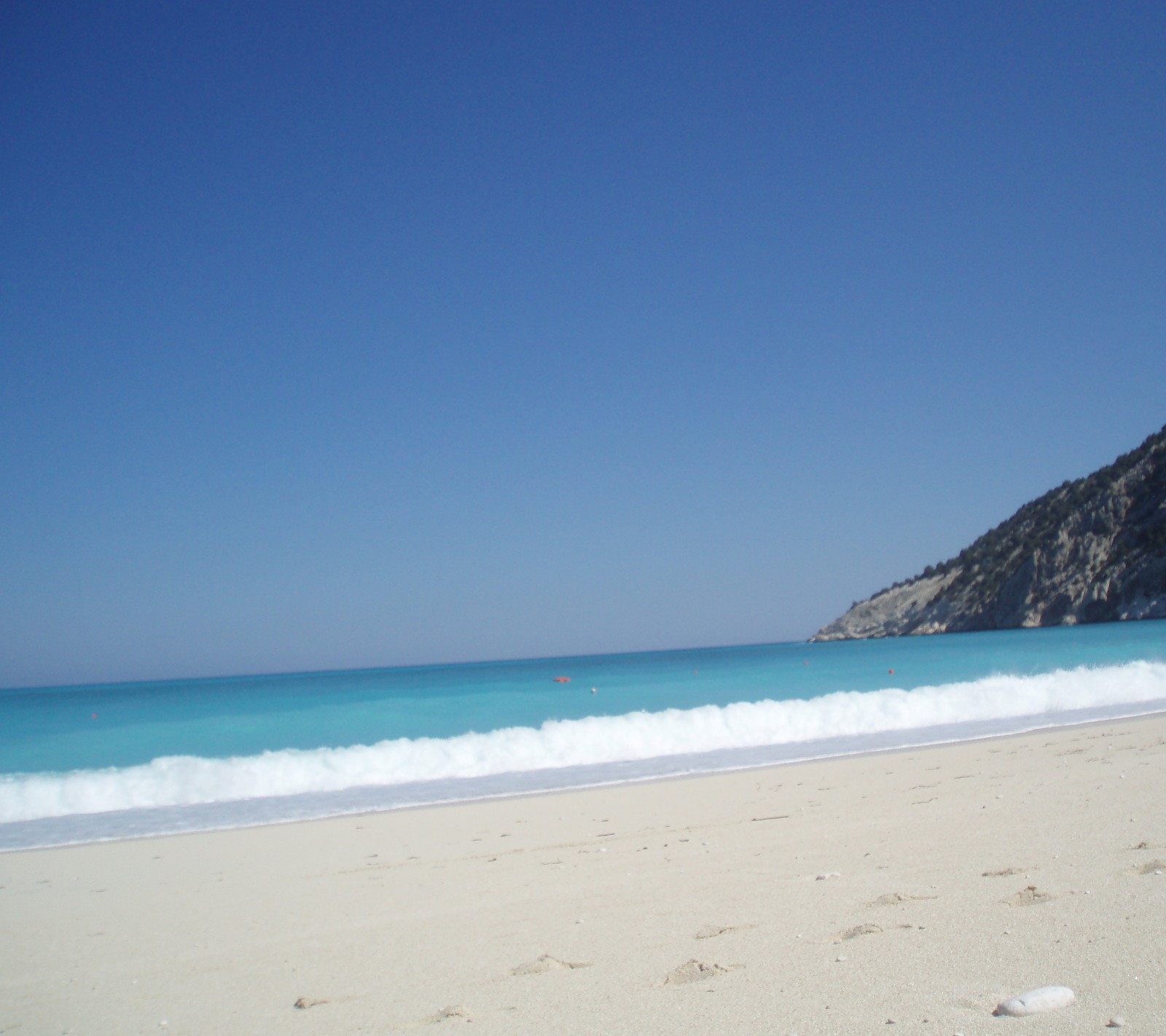 There is a blue ocean and a mountain in the background (nature p, r nature)