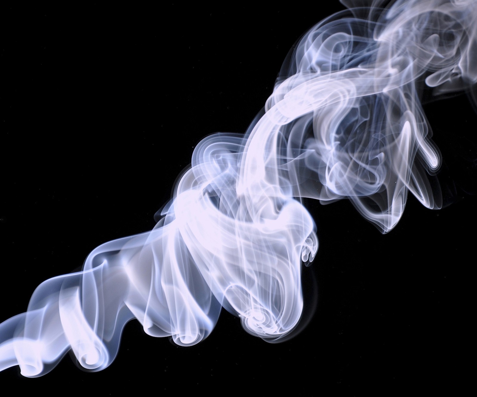 Smoke is swirling in the air on a black background (abstract, smoke)