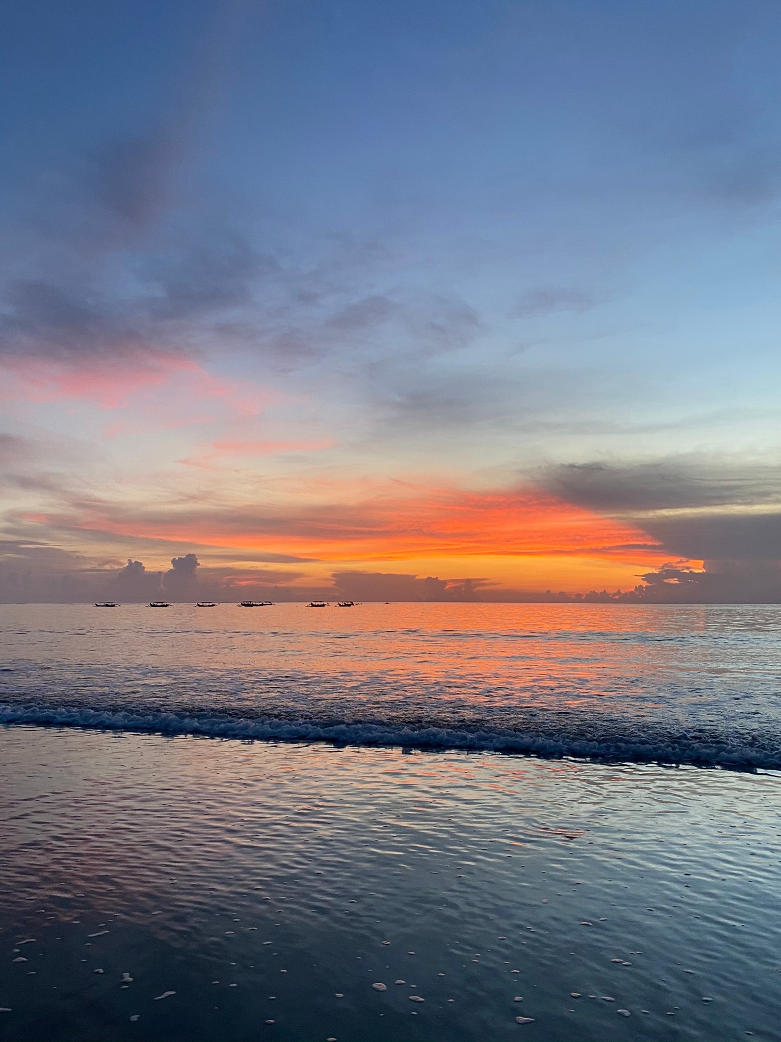 Sunset over the ocean with a boat in the distance (tourist attraction, fluid, liquid, cloud, dusk)