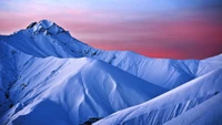 Majestic Snow-Capped Peaks Under a Colorful Sky