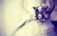 Elegant Bride in a White Ball Gown Holding a Floral Bouquet of Roses and Baby's Breath