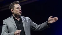 Elon Musk delivering a dynamic speech on innovation and technology.