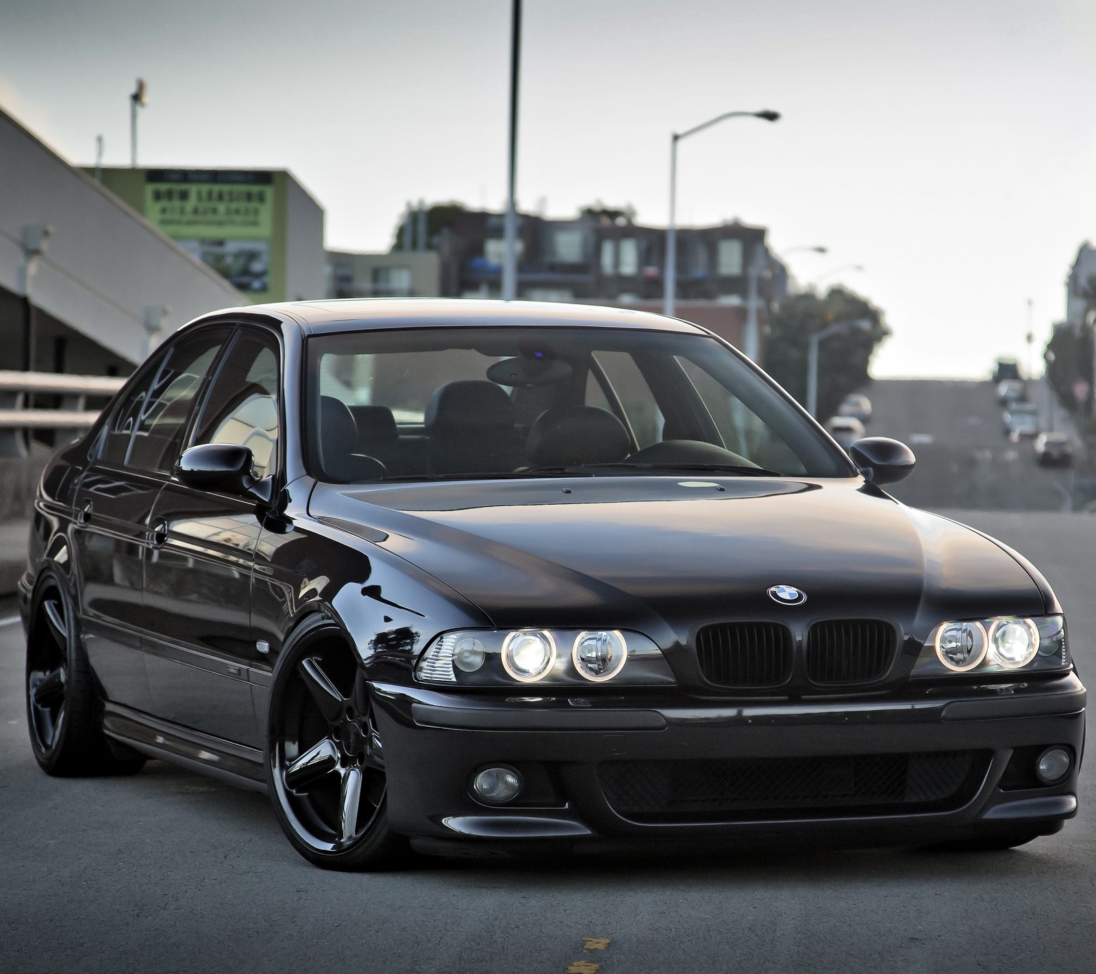 Bmw e36 sedan with a black paint job parked in a parking lot (auto, bimmer, bmw, car, m5)