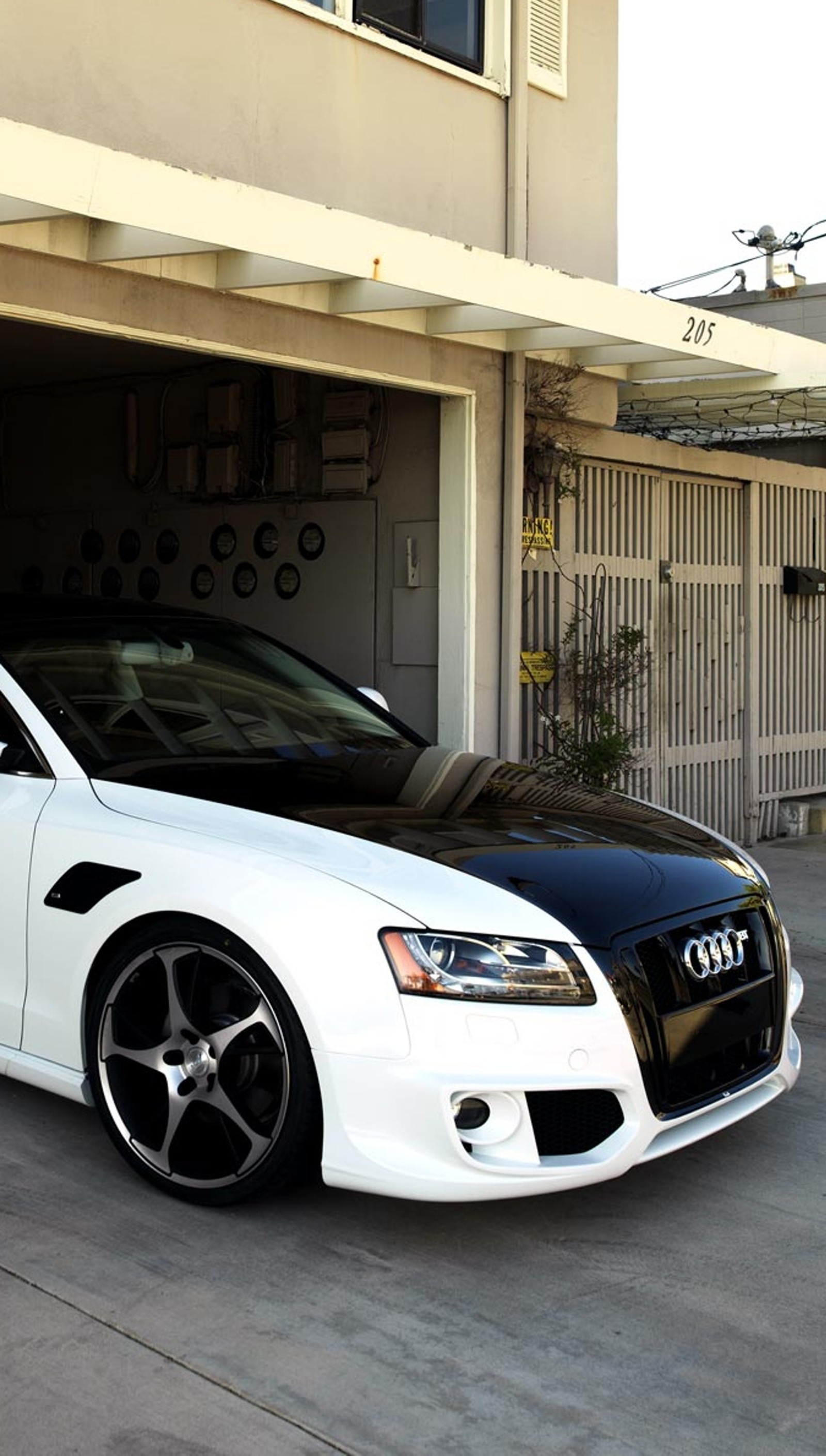 Arafed audi car parked in front of a garage with a clock on the wall (audi s5, car, tuned)