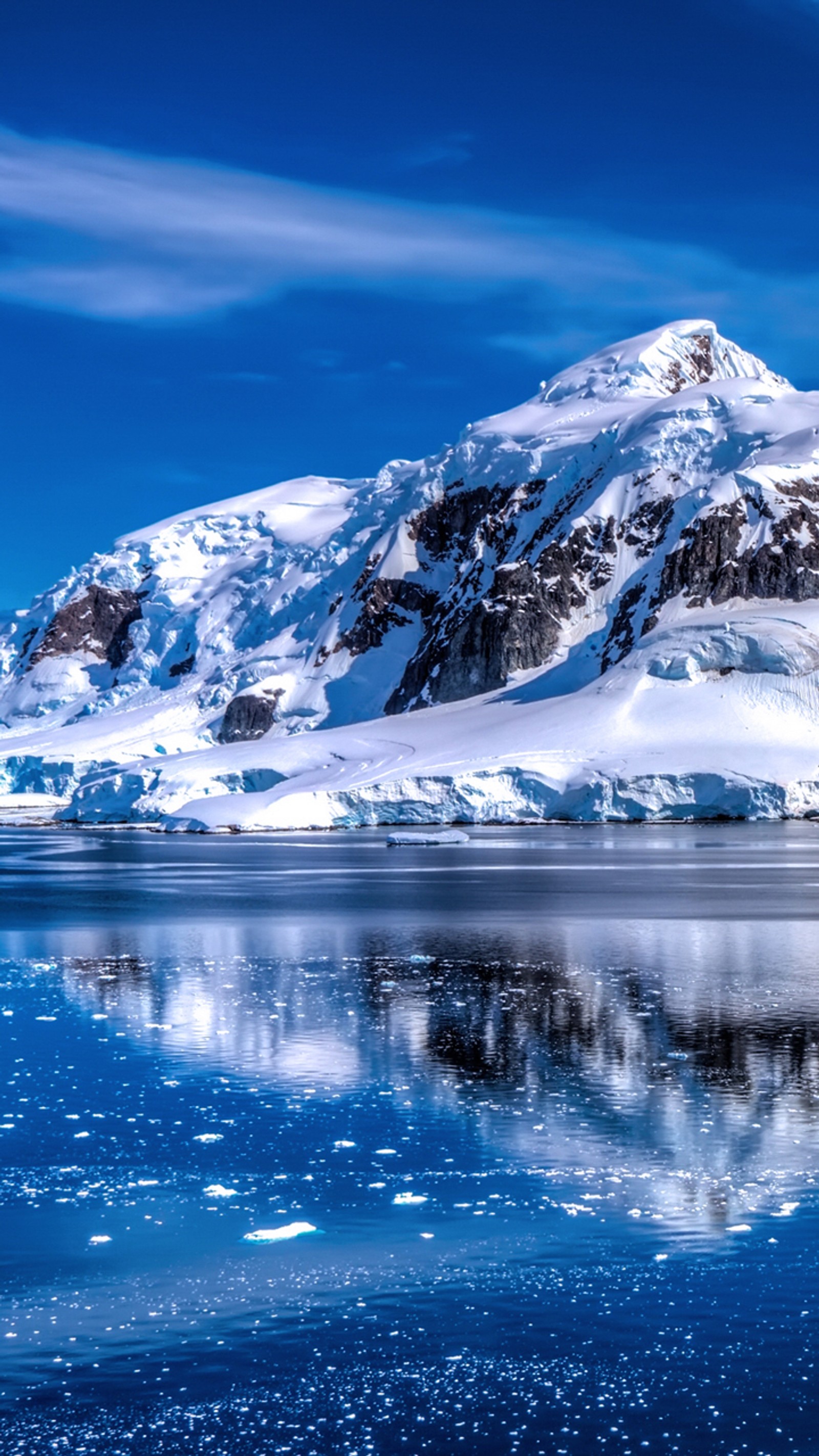 Mountains are reflected in the water of a lake with ice (blue, landscape, mountains, reflection)