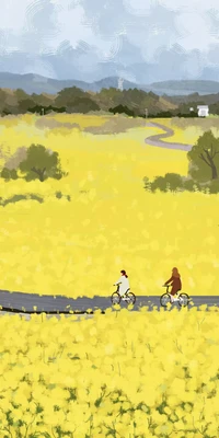 Two cyclists riding through a vibrant canola field under a cloudy sky.