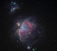 Stunning view of the Orion Nebula, showcasing vibrant star formation amidst a backdrop of distant stars and cosmic dust.