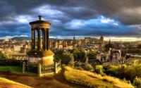 Dugald Stewart Monument overlooking the Edinburgh cityscape at sunset.